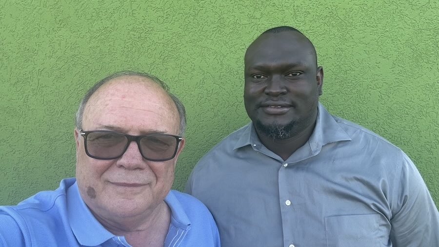 Two men standing next to each other