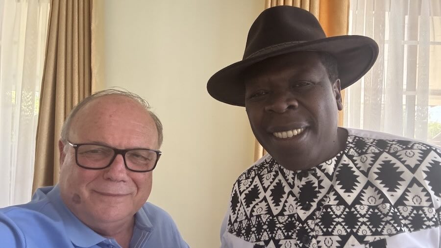 Two men smiling at the camera