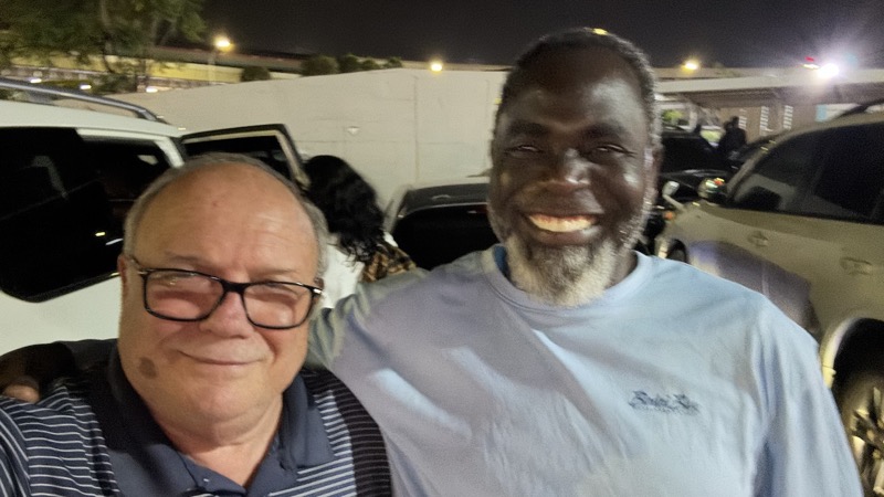 Two men standing together smiling