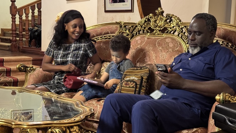 A family sitting on a couch