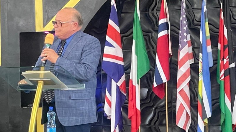 A person standing at a podium with a microphone