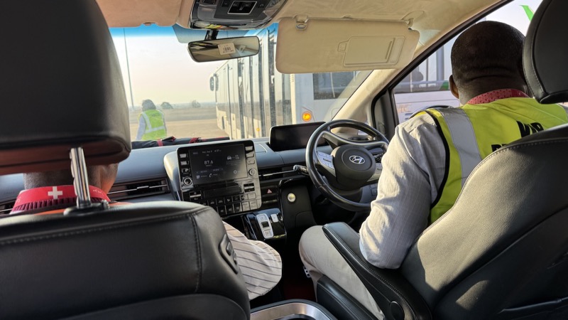 A person in a yellow vest in a car