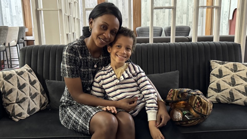 A person and a child sitting on a couch