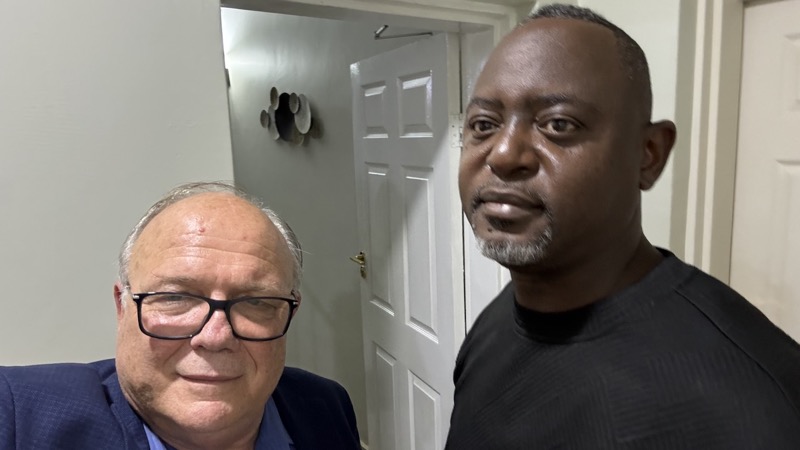 Two men standing next to each other