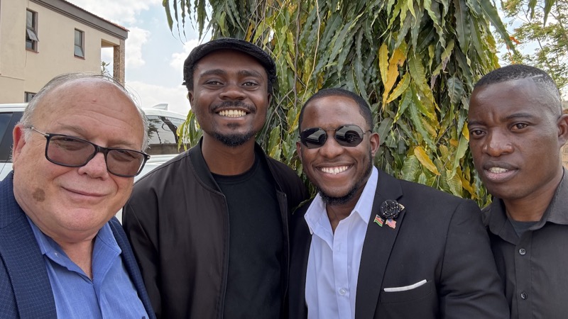 A group of men smiling for a picture