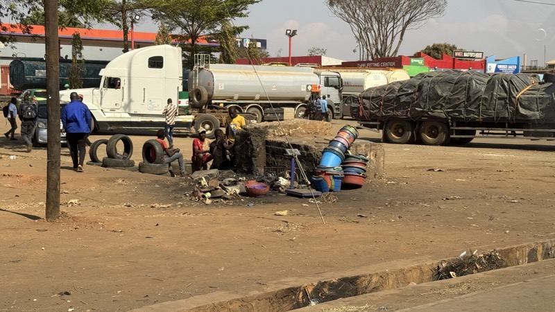 A group of people sitting on a pile of tires