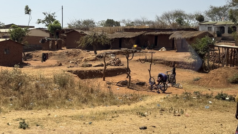 A dirt field with a person in a bicycle with medium confidence
