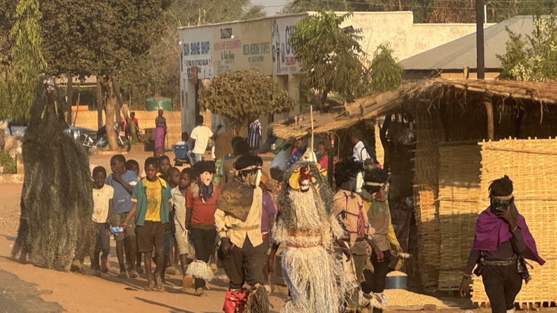 A group of people walking in a village