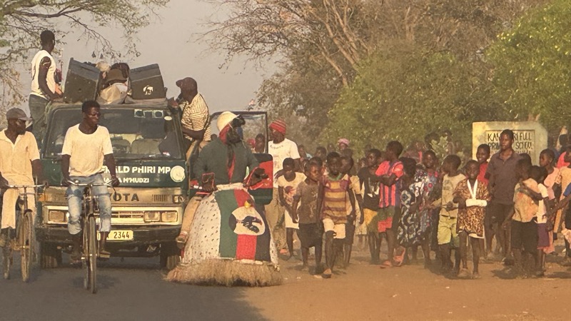 A group of people walking on a road