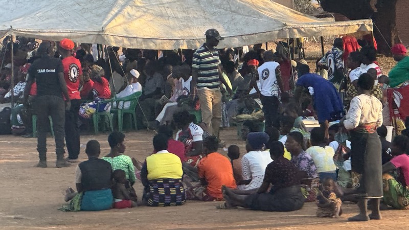 A group of people sitting on the ground
