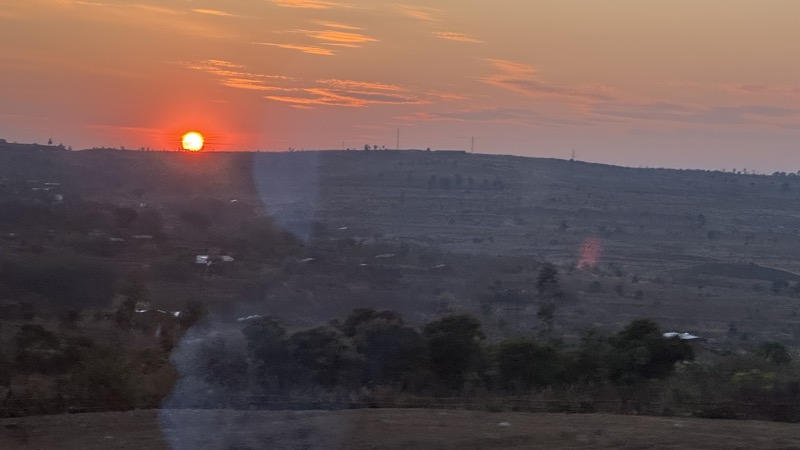 A sunset over a hill
