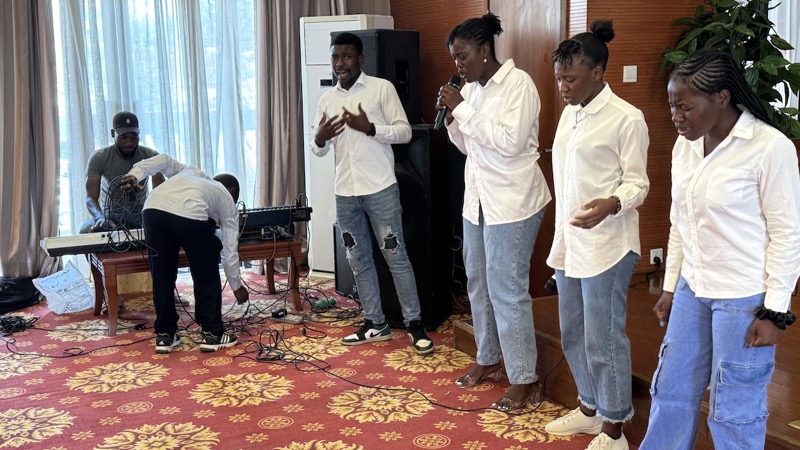 A group of people singing in a room