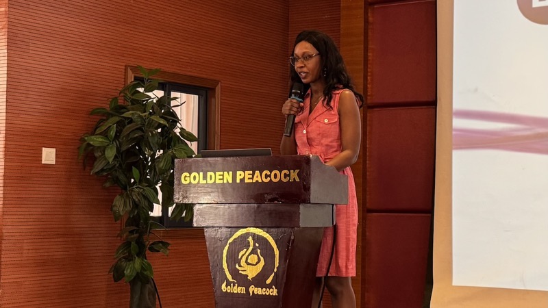 A person standing at a podium with a microphone