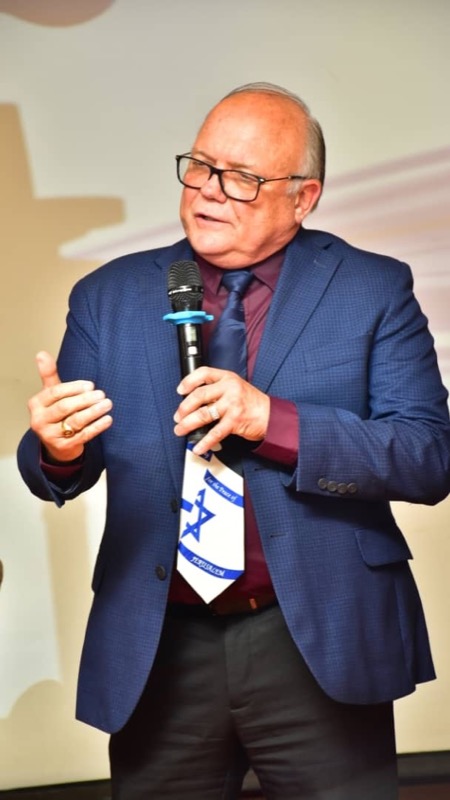 A person in a suit holding a microphone
