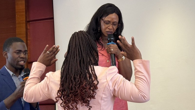 A person holding a microphone and talking to a person