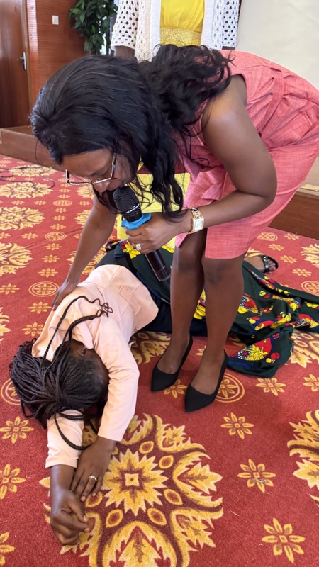 A person holding a microphone to a child's head
