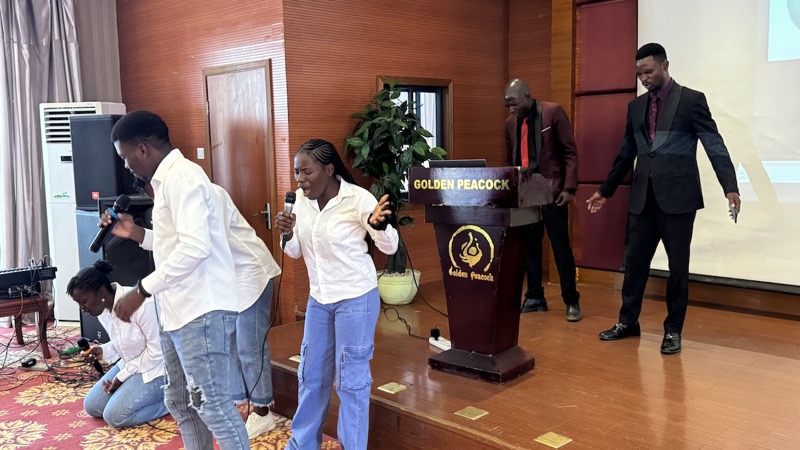 A group of people singing in a room