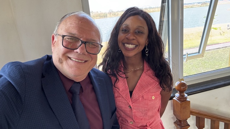 A person and person smiling for a picture