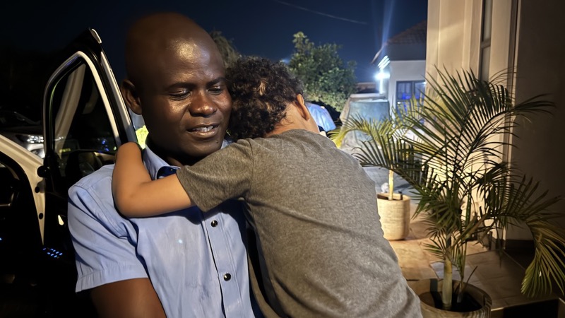 A person hugging a child
