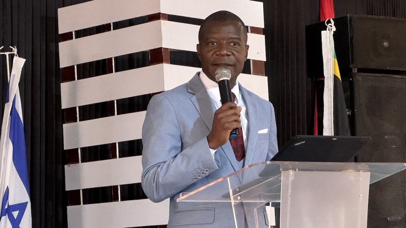 A person in a suit holding a microphone