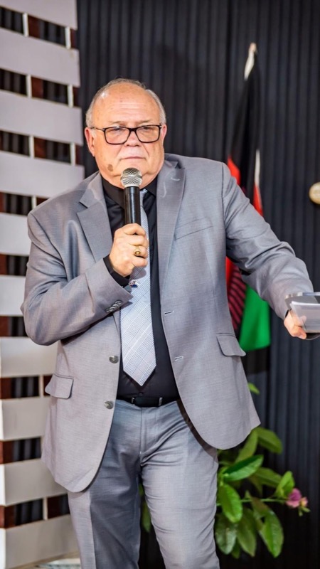 A person in a suit holding a microphone