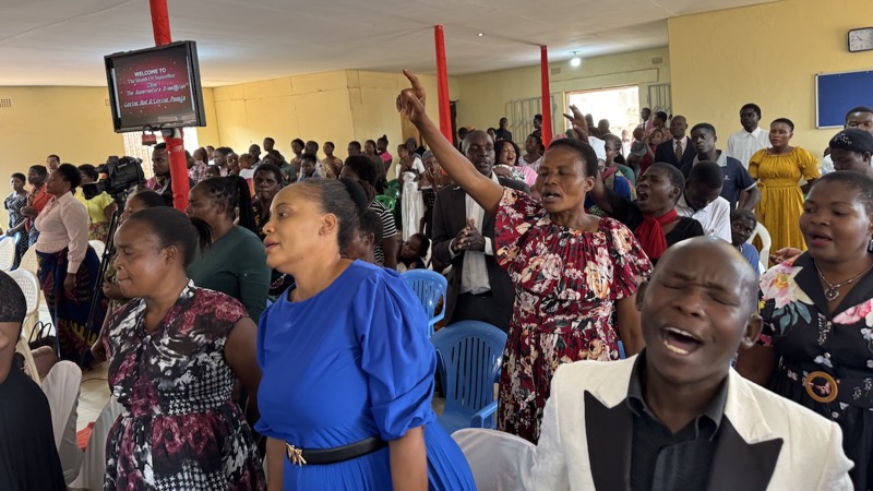 A group of people singing in a room