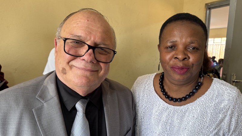A person and person smiling for a picture