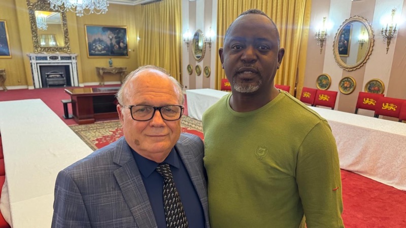 Two men standing together in a room