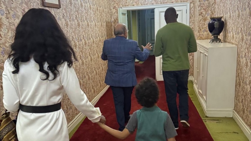 A group of people walking in a hallway