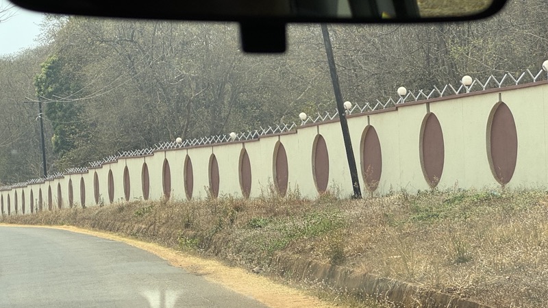 A long white wall with round windows