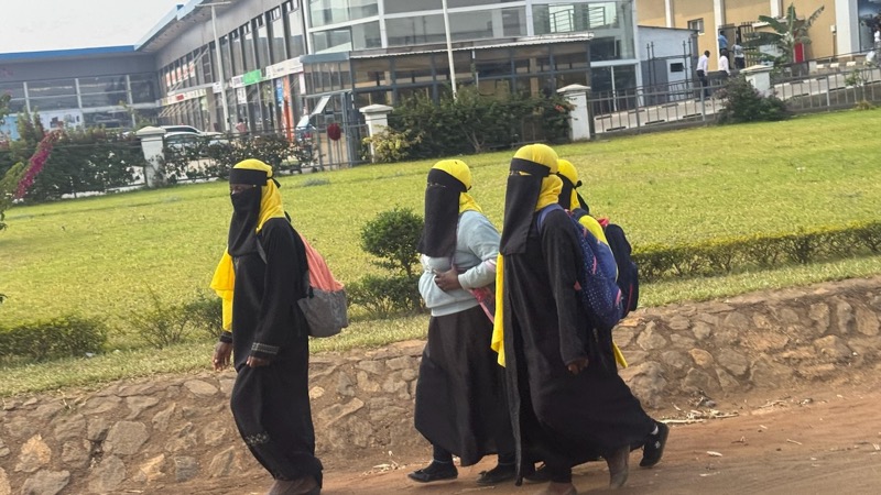 A group of people wearing black and yellow clothes