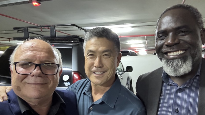 A group of men smiling for a photo
