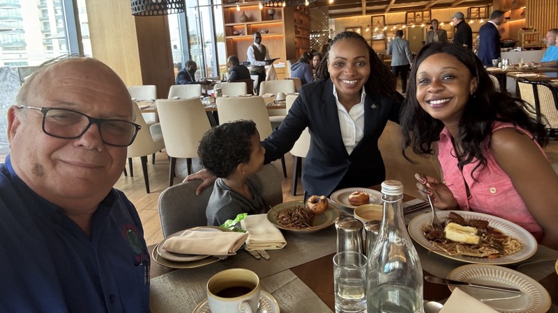 A group of people sitting at a table with food