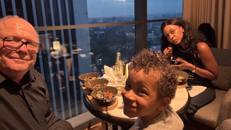 A group of people sitting at a table with food