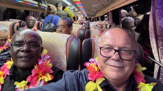 A group of people with flowers around their neck