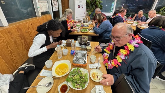 A group of people eating at a restaurant