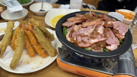 A plate of food next to a plate of fried food