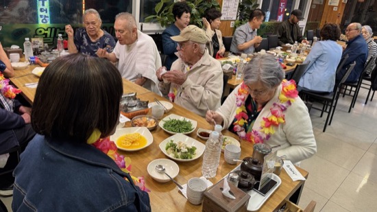 A group of people sitting at a table eating food