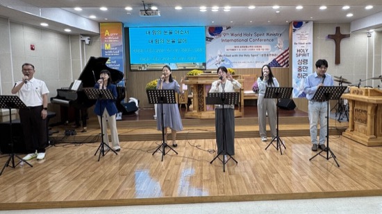 A group of people singing on stage