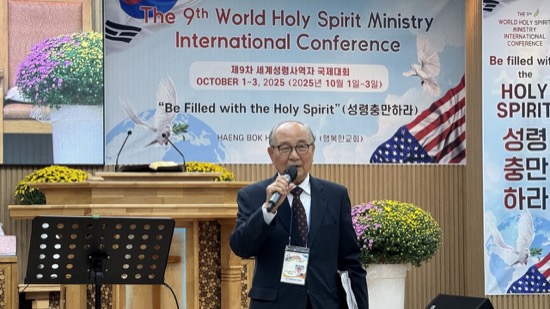 A person in a suit speaking into a microphone