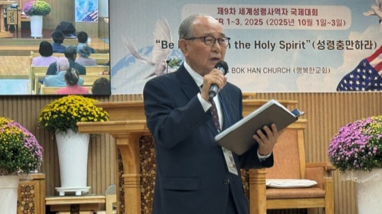 A person in a suit holding a microphone and a book