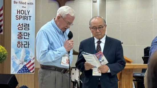 A person holding a microphone and speaking to another person