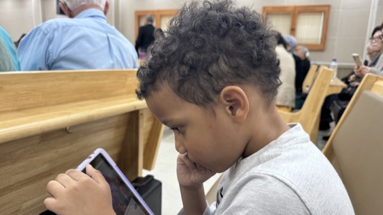 A child looking at a tablet
