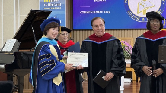 A person and person in graduation gowns