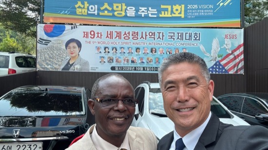 Two men standing together smiling
