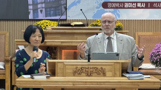 A person and person standing at a podium