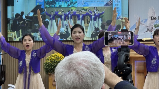 A person in purple dress with her hands up in front of a person