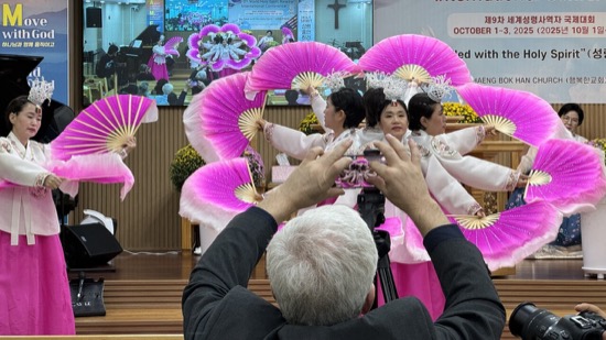 A person taking a picture of a group of women