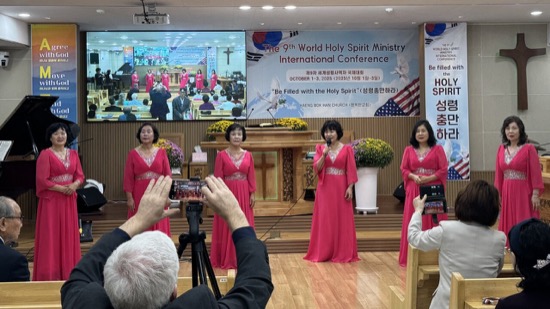 A group of women in red dresses performing on stage