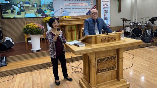 A person and person standing at a podium